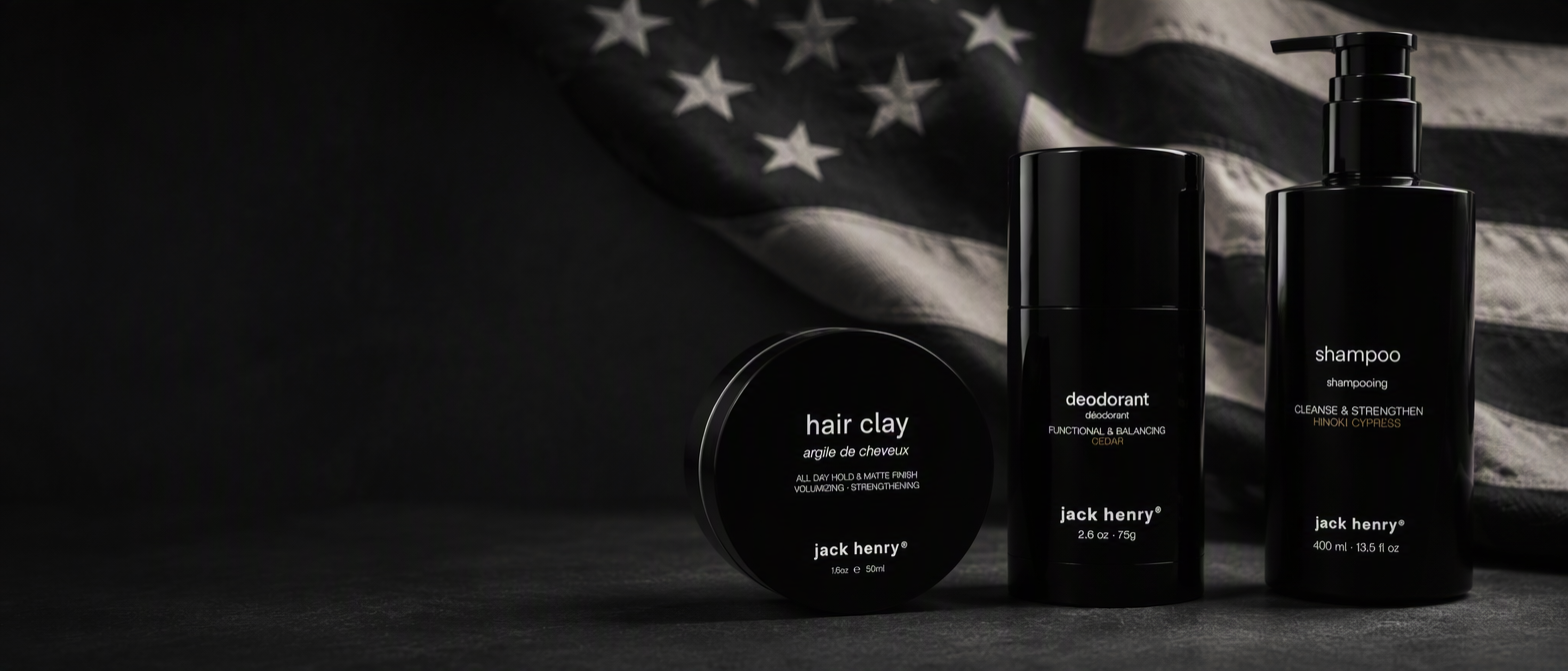 Jack Henry hair clay, deodorant and shampoo on a monochrome American flag